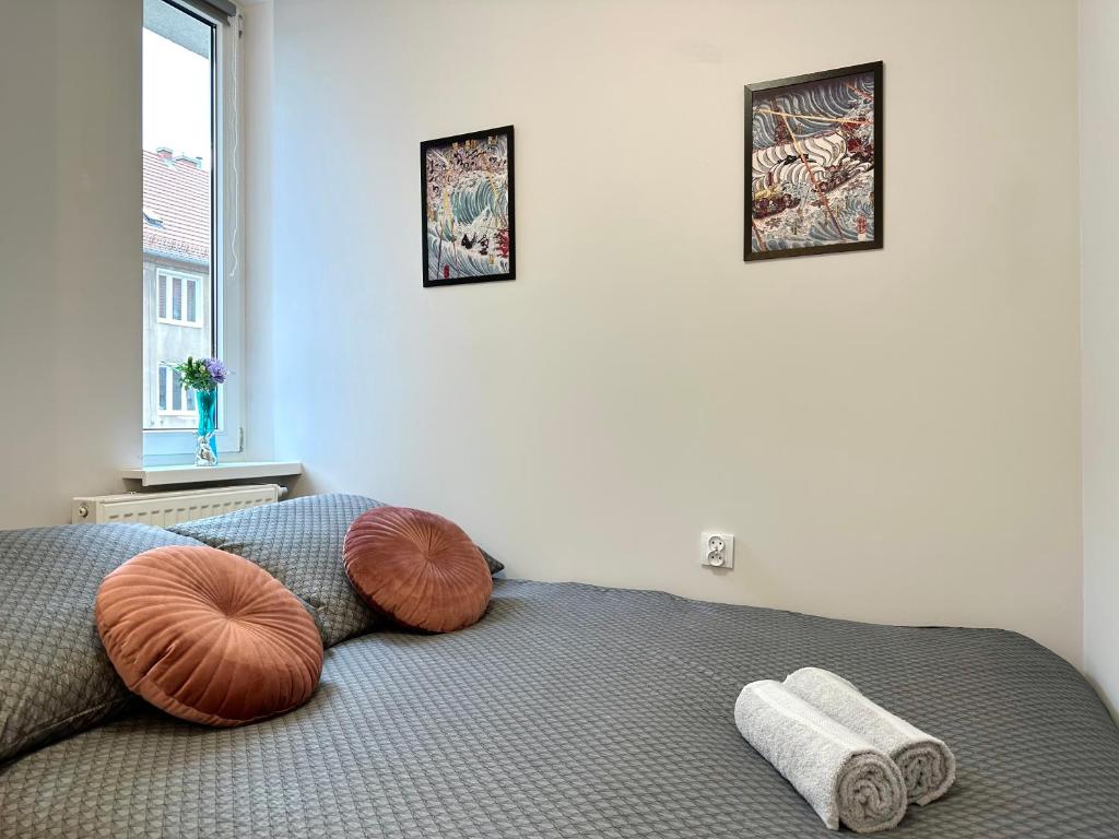 a bedroom with a bed with two pillows on it at MMRent Pirate Room in Gdańsk