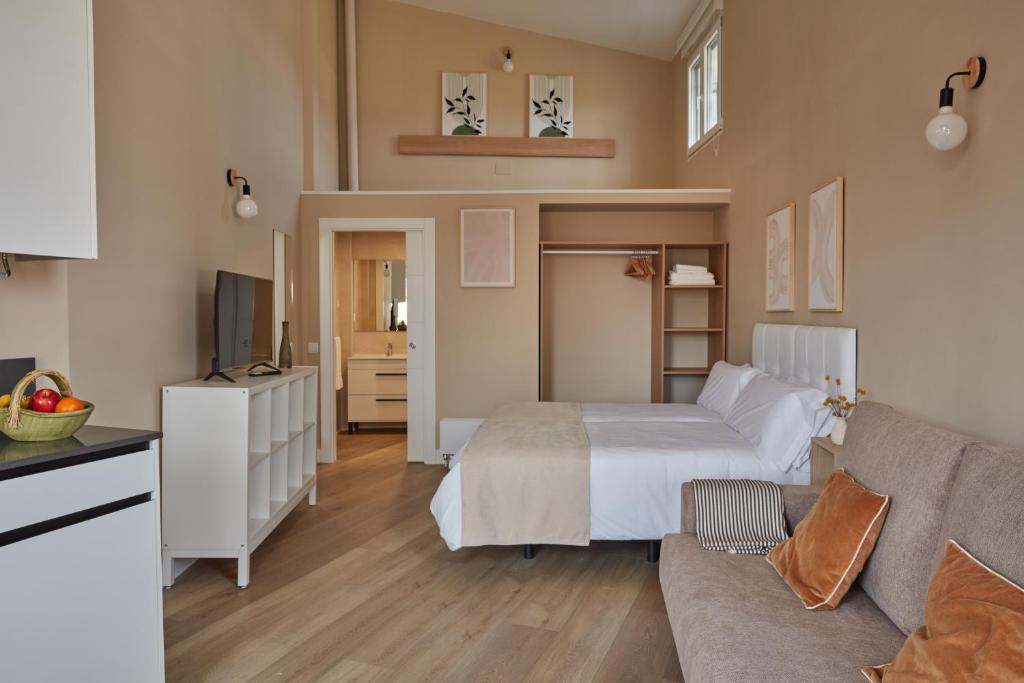 um quarto com uma cama e uma sala de estar em Apartamentos Cuerda Larga em Madri