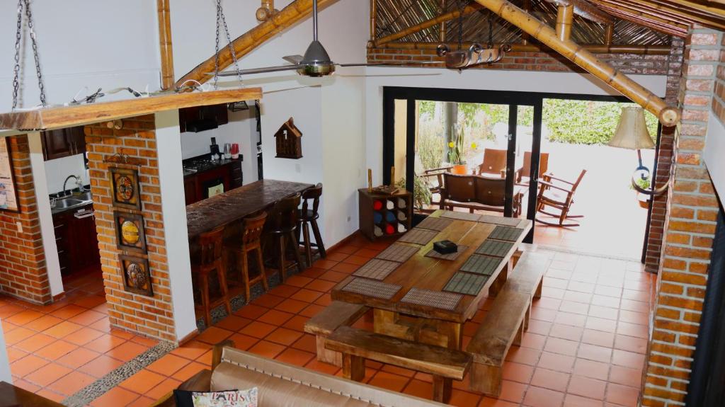 a kitchen with a wooden table in a room at Finca PANACA Jagüey 12 VIP Group - Villas for Rent in in Quimbaya