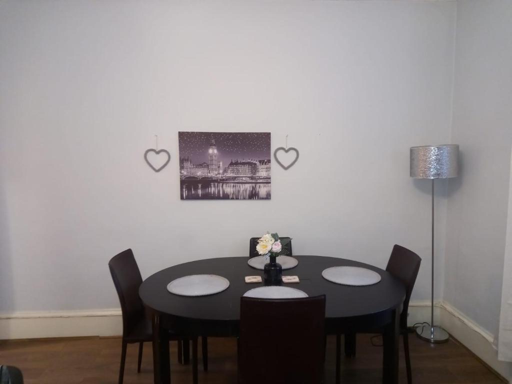 a dining room with two tables and two hearts on the wall at 1 Bedrooms Flat in Central Edinburgh Haymarket, Heart of Edinburgh Flat Sleeps 4 in Edinburgh