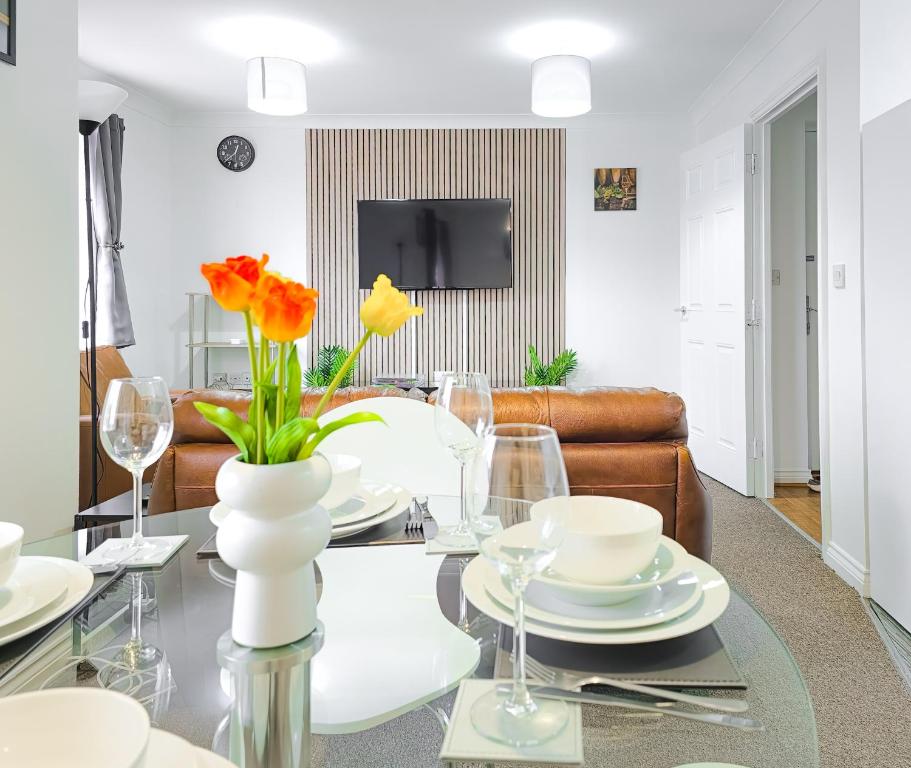 a living room with a table with yellow flowers on it at Deluxe 2-bed Apartment, Family friendly, Free Parking, Netflix & Amazon Prime Video Streaming in Farnworth
