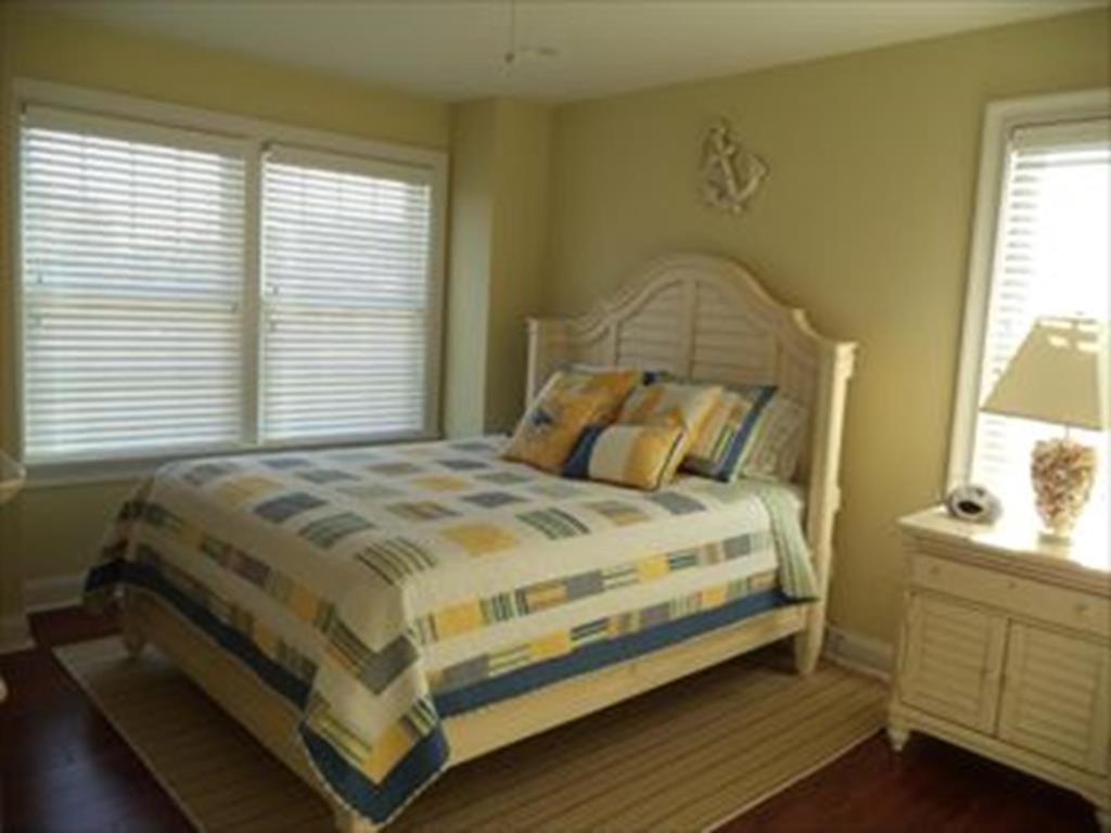 a bedroom with a bed and two windows at 16351 Hesser - 3br 2 Ba Home in Beach Haven Gardens