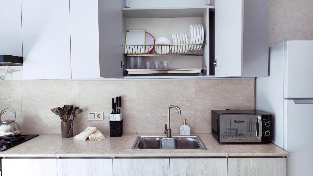 a kitchen counter with a sink and a microwave at Mountain View Two in Tashkent