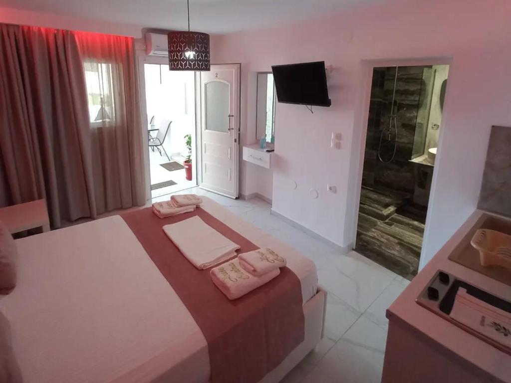 a bedroom with a bed and a television in it at House Blerina in Sarti