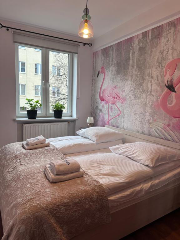 a bedroom with two towels on a bed at Maya's Flats & Resorts 47 - Heweliusza Gdansk in Gdańsk