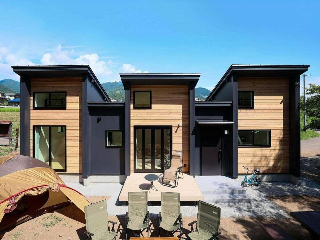 a house with a group of chairs in front of it at SENKO TINY CAMP - Vacation STAY 34705v in Ueda