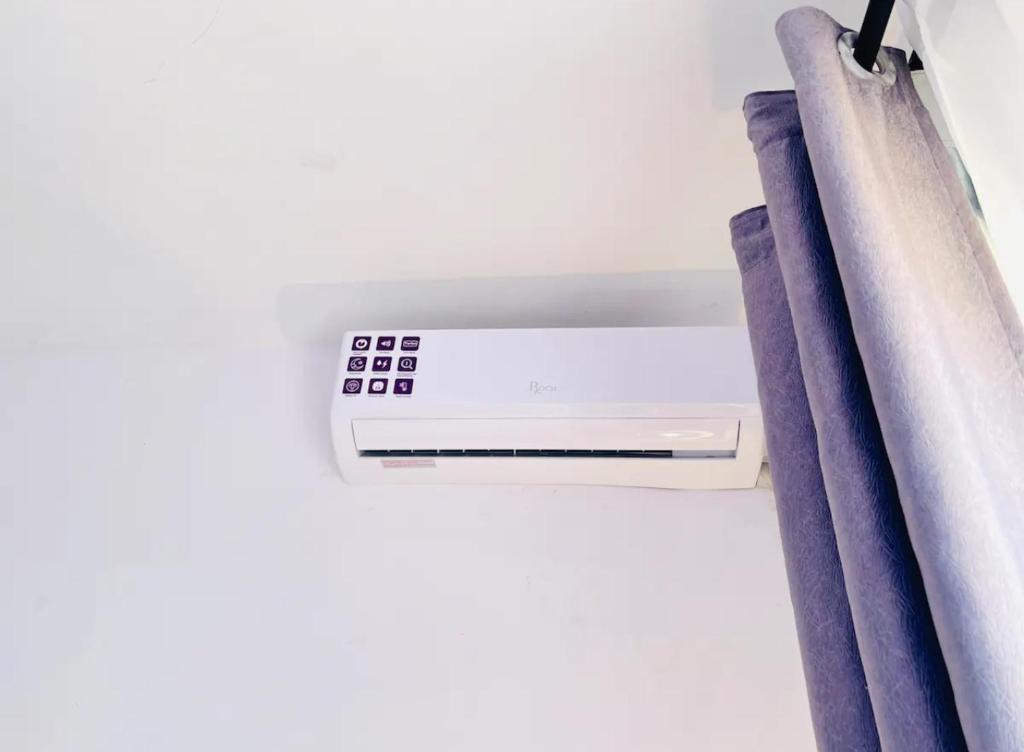 a close up of a air conditioner in a room with curtains at Unique apartment in Mombasa