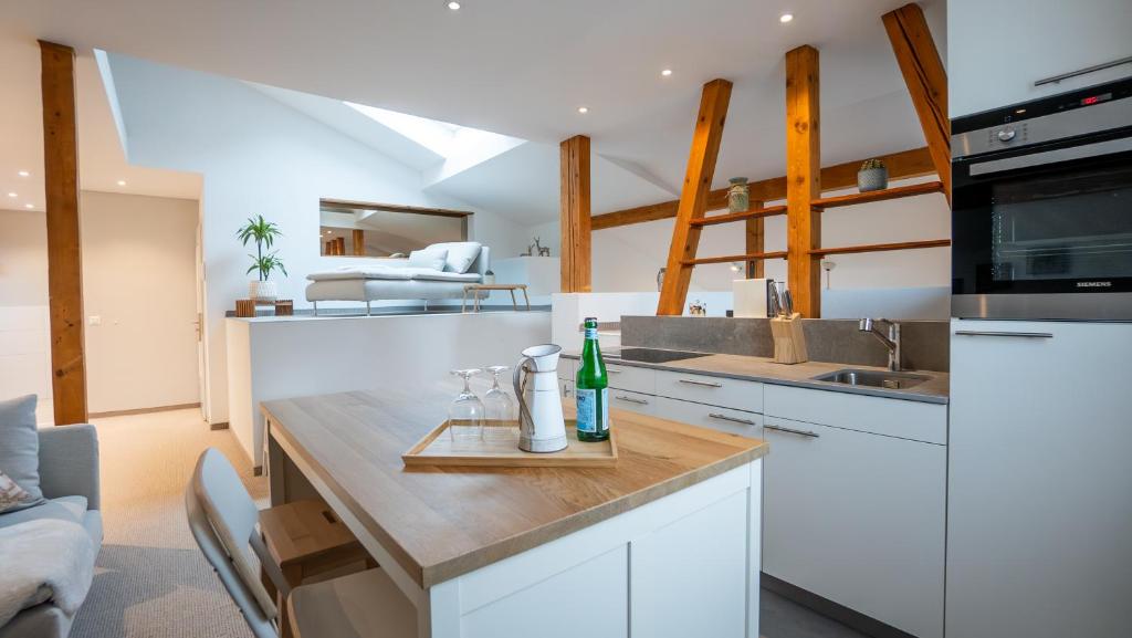 a kitchen with a counter with a bottle on it at Hotel & Restaurant Rössli in Stansstad