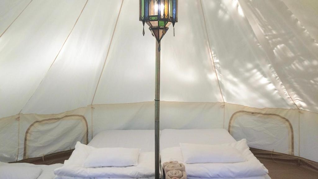 a tent with two beds in it with a lamp at Shimanto Yamamizuki - Vacation STAY 36958v in Shimanto