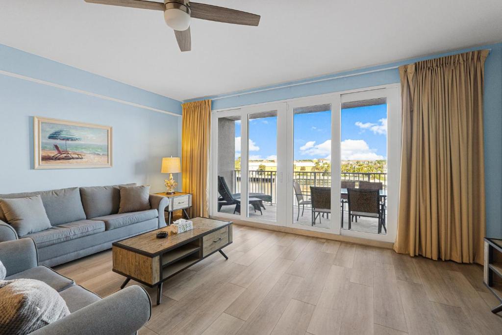 a living room with a couch and a table at Lovely Resort Low Floor Condo! Just Steps to the Beach & Restaurants! by Dolce Vita Getaways PCB in Panama City Beach