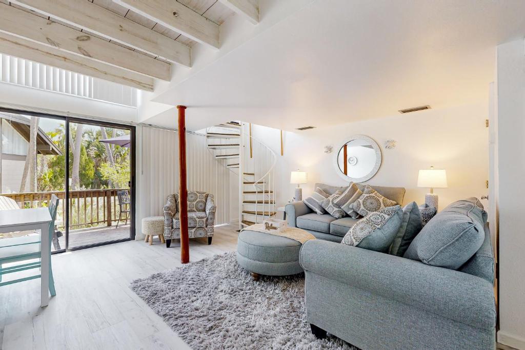 a living room with a blue couch and a table at Peaceful River Bungalow in Crystal River