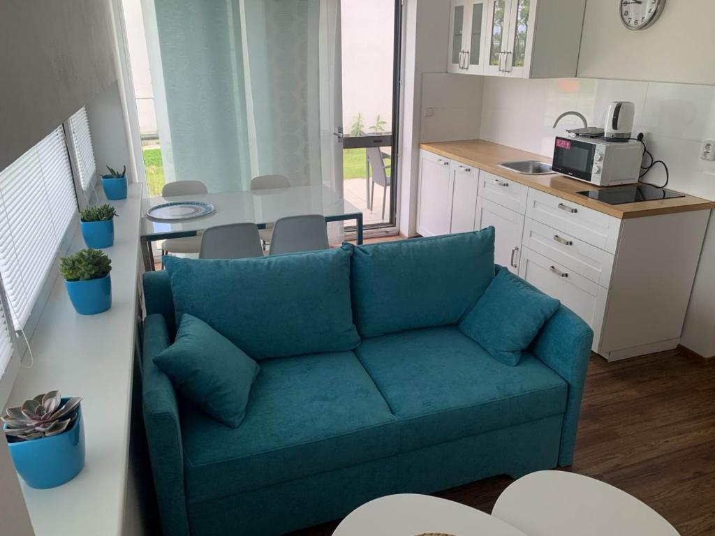 a living room with a blue couch in a kitchen at B4 Apollon resort in Lednice