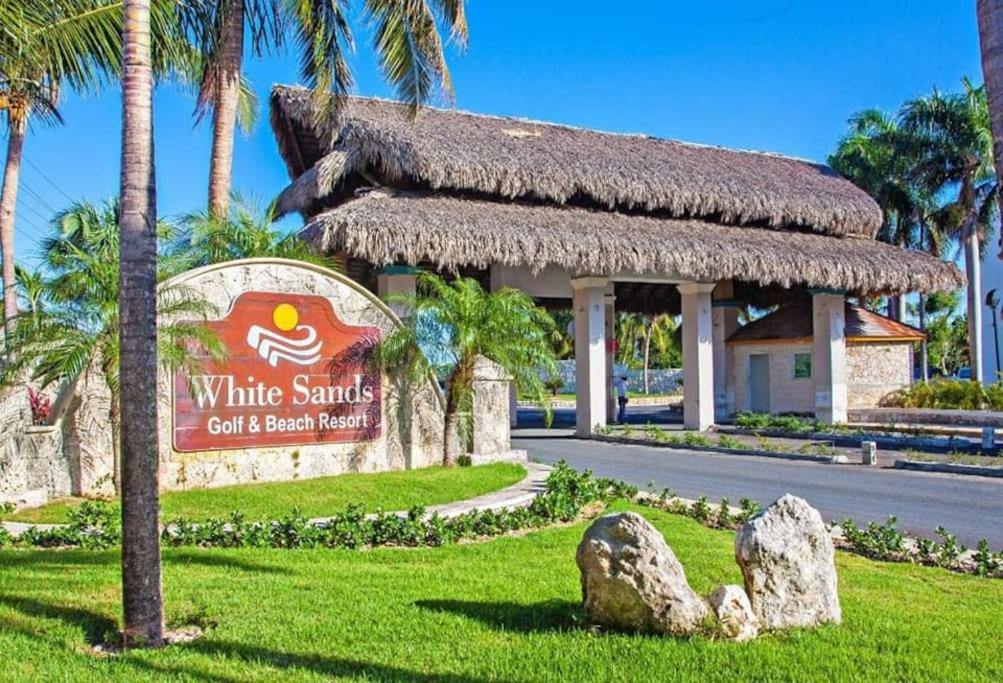 a sign for a white sands golf and beach resort at MagicCana arena blanca beach in Punta Cana