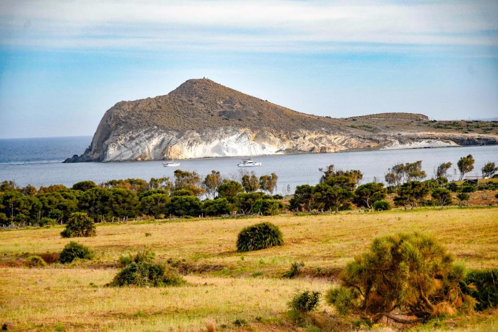 a view of a island in the water with boats at Carboneras, maravillate de su paraiso natural in Carboneras