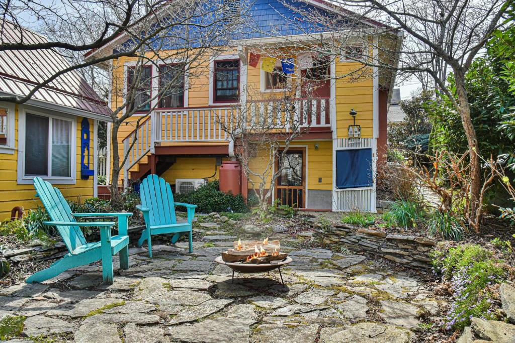 a yard with two chairs and a fire pit in front of a house at Zen Studio in Asheville