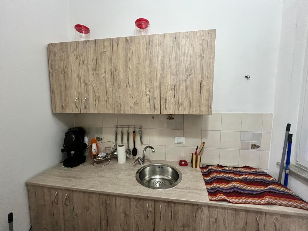 a kitchen counter with a sink and a cupboard at House del Corso Calatafimi in Palermo