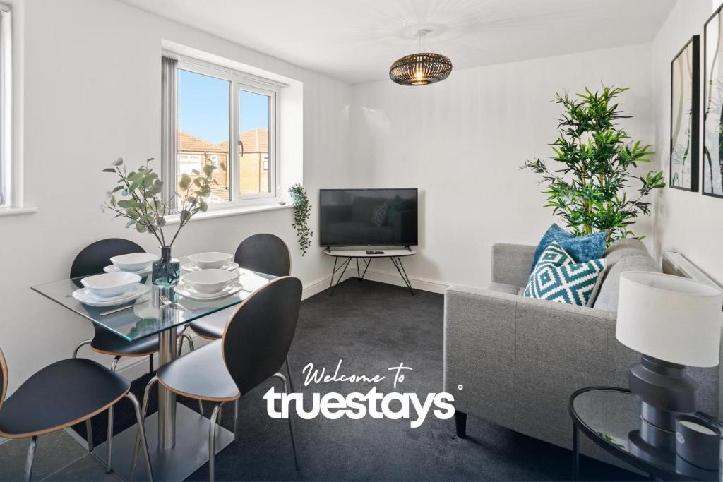 a living room with a table and a couch at NEW 4 Sarah House by Truestays - 2 Bedroom Apartment - FREE Wifi & Parking in Manchester