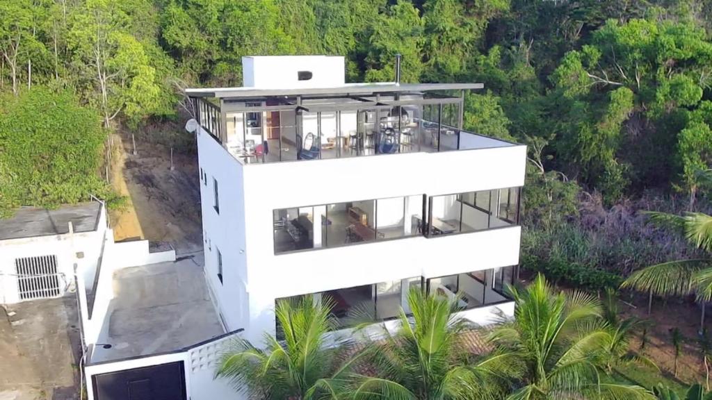 an aerial view of a white building with trees at Reserva Santa Helena in Anchieta
