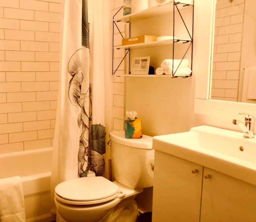 a bathroom with a toilet and a sink at Sungate on Salt Spring BnB in Salt Spring Island