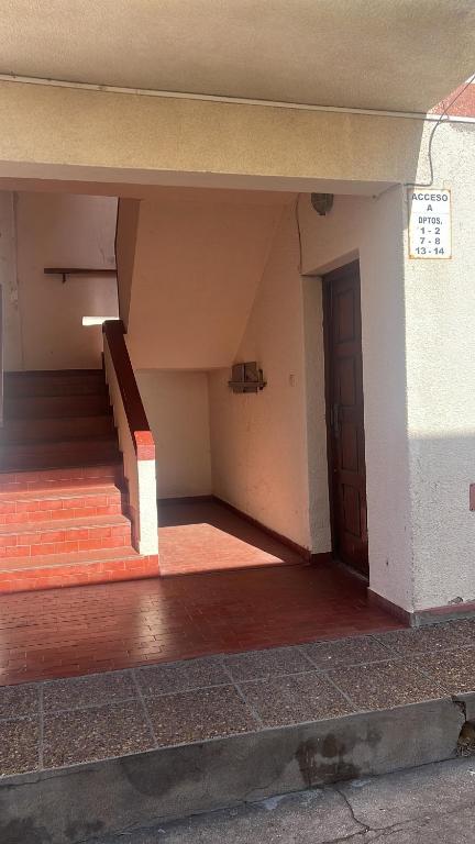 an empty building with stairs and a door at Departamento céntrico in Monte Hermoso
