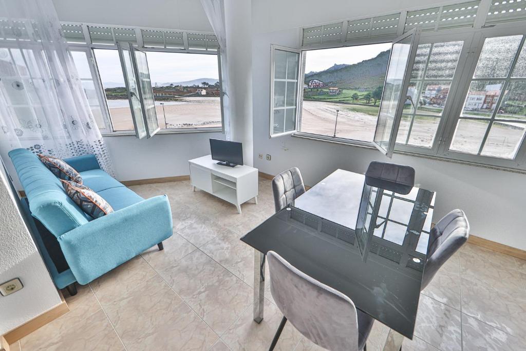 a living room with a couch and a table at Apartamentos Camelle in Camelle