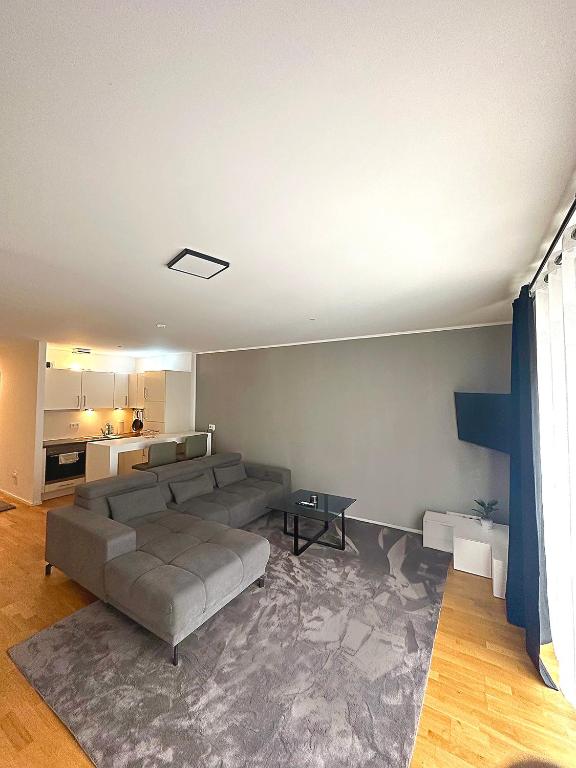 a living room with a couch and a table at CityLife Apartments Stuttgart Europa Viertel in Stuttgart