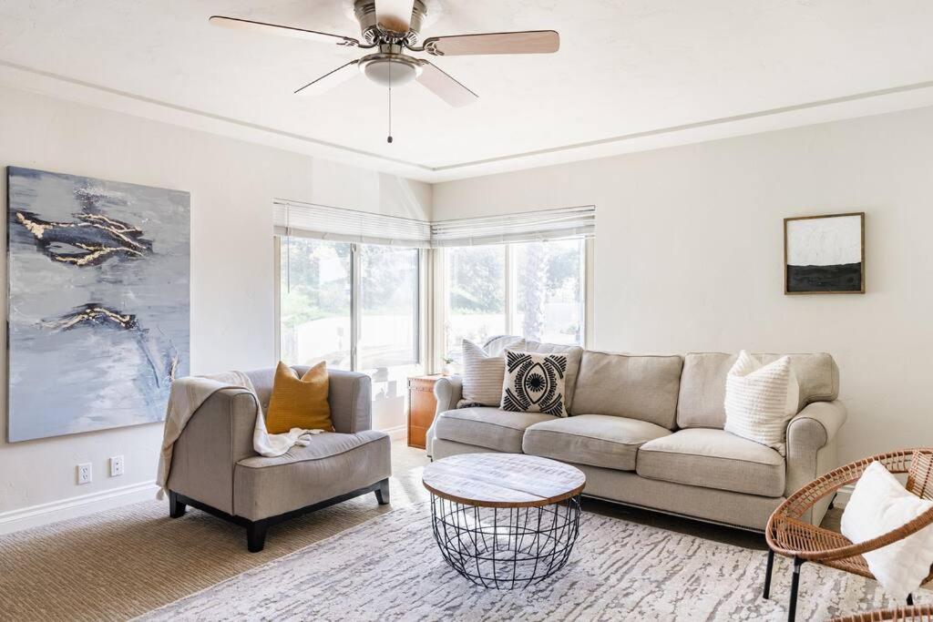 a living room with a couch and a ceiling fan at Casa Flora -2BR- FREE Parking in Little Italy! in San Diego