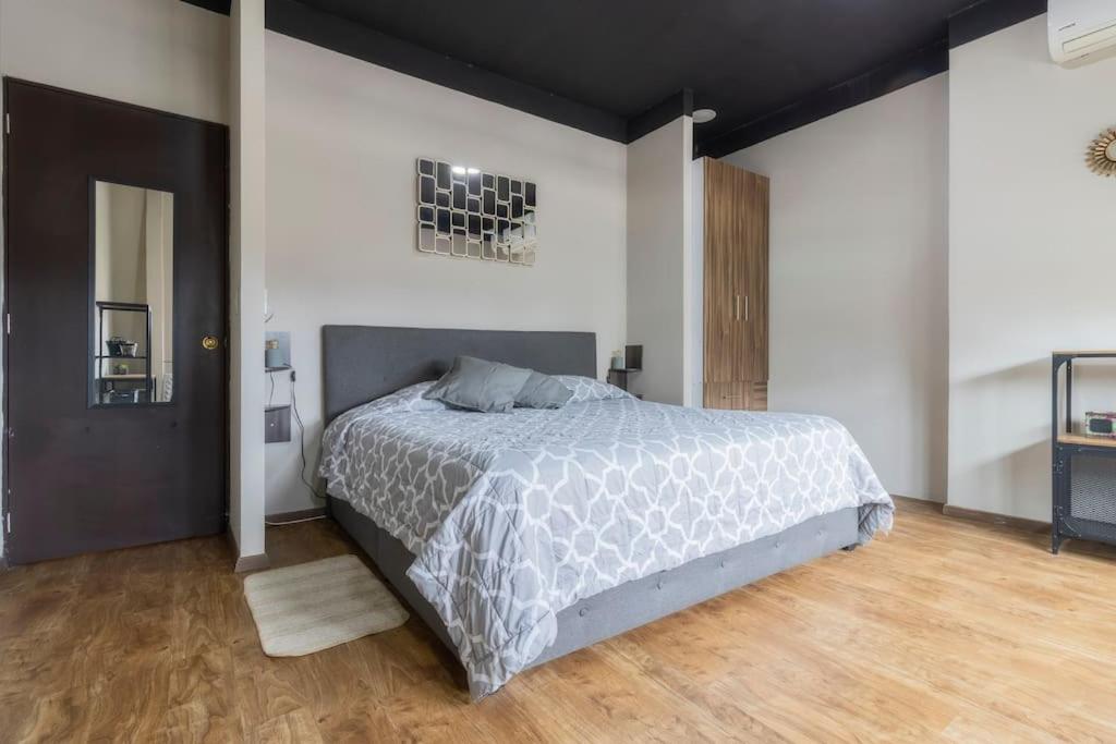 a bedroom with a large bed in a room at 506 Great Location AC 1Bdrm 1bath apt Rooftop in Mexico City