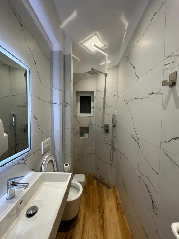 a bathroom with a sink and a toilet at Arial Lofts in Vlorë