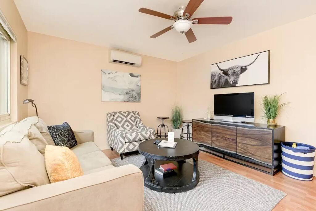 a living room with a couch and a flat screen tv at Casa Amore -2BR- FREE Driveway parking for 3 cars in San Diego