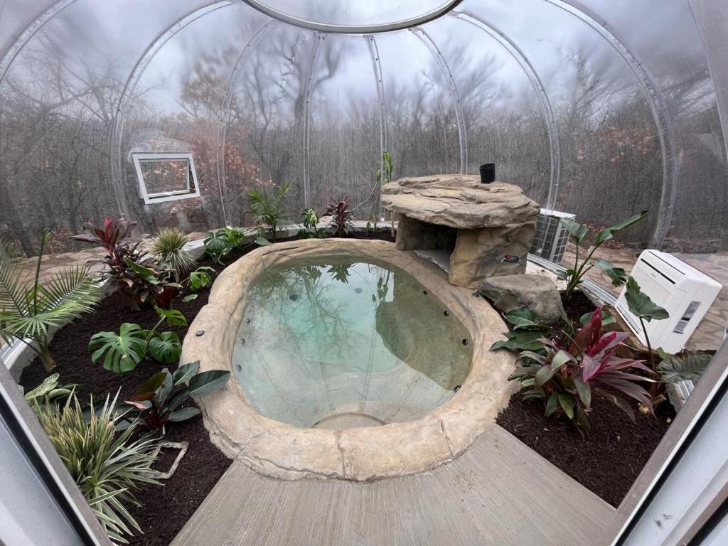 un jardín con una gran piscina en un invernadero en New Lux Cabin Hot Tub FirePit Games, 