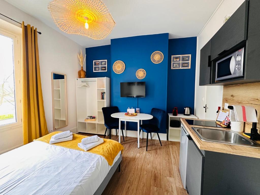 1 dormitorio con 1 cama y cocina con fregadero en Le Quai Saint Laurent - BY PRIMO C0NCIERGERIE, en Orléans