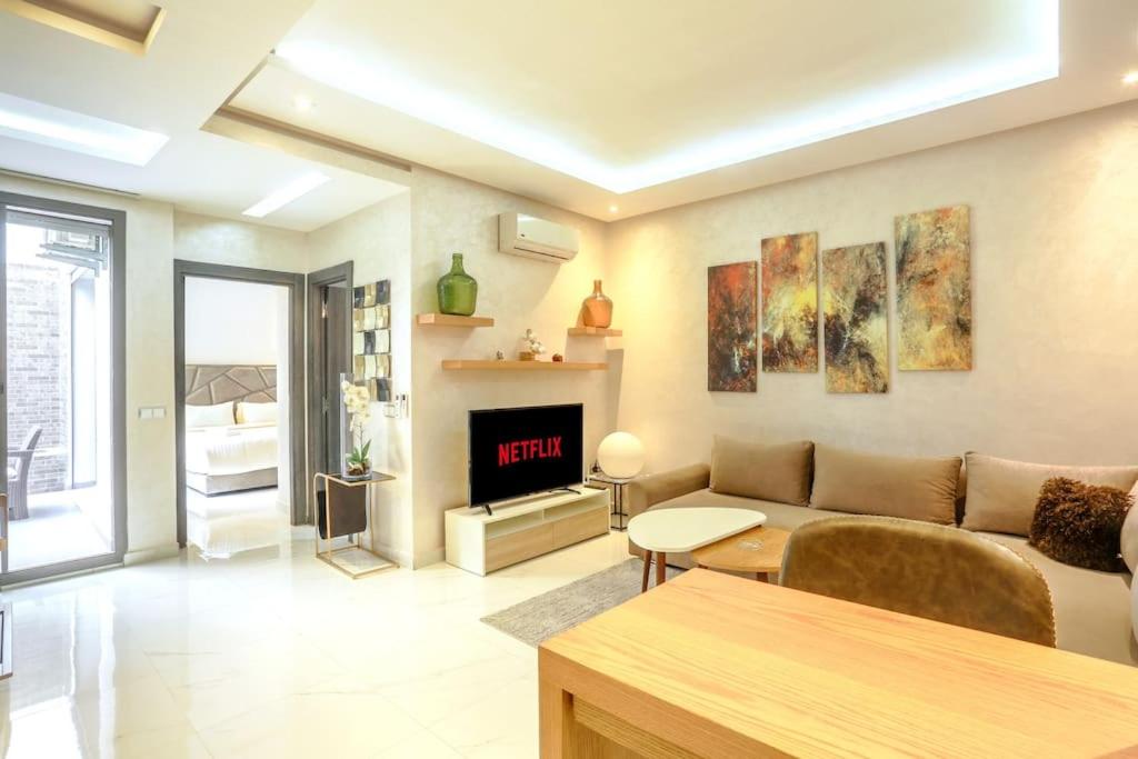 a living room with a couch and a fireplace at Résidence Sheren - Maarif in Casablanca