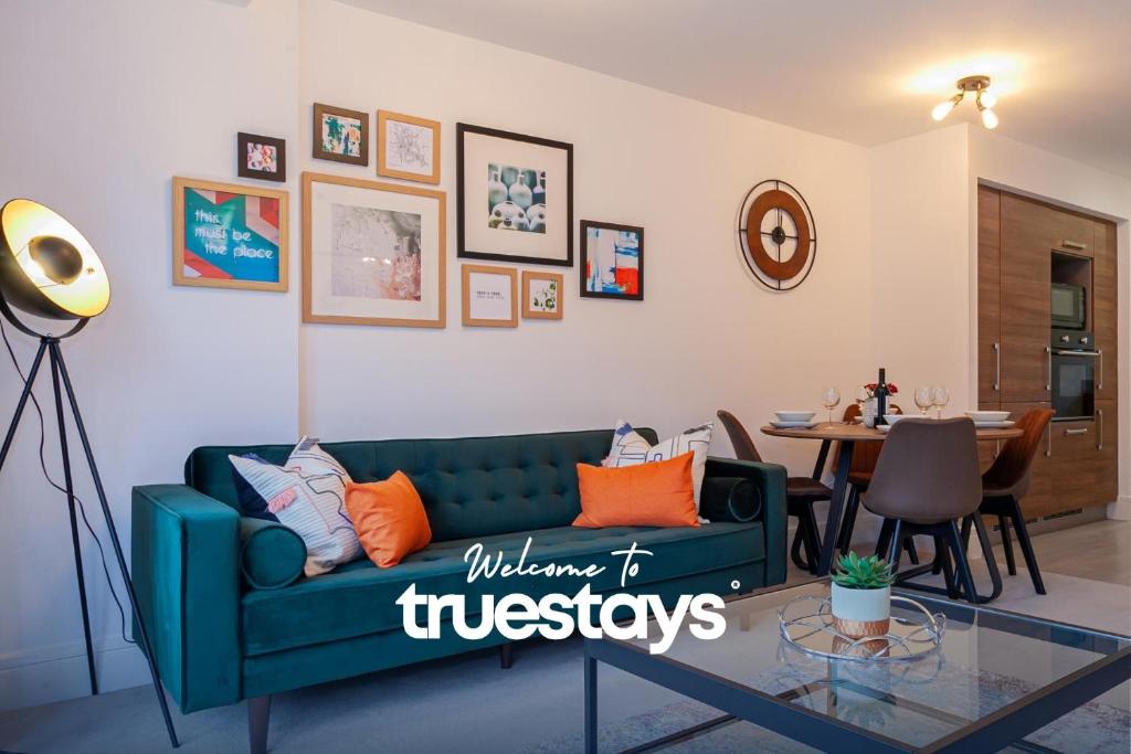 a living room with a green couch and a table at Ambassador House by Truestays - Luxury 4 Bedroom House in Stoke-on-Trent in Etruria