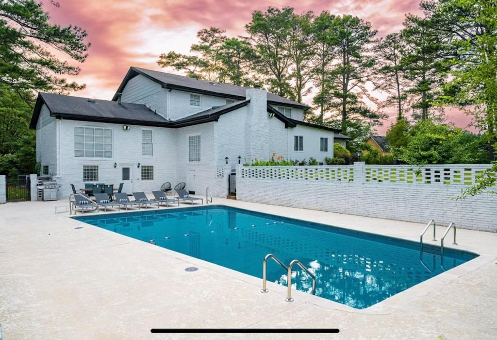 a swimming pool in front of a house at Mansion With Private Pool Basketball & Tennis courts in Fayetteville