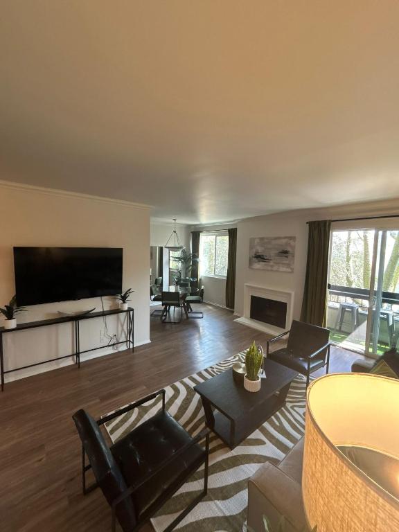 a living room with a large flat screen tv at Beverly Hills Midle City 1 br Apt with Parking 202 in Los Angeles