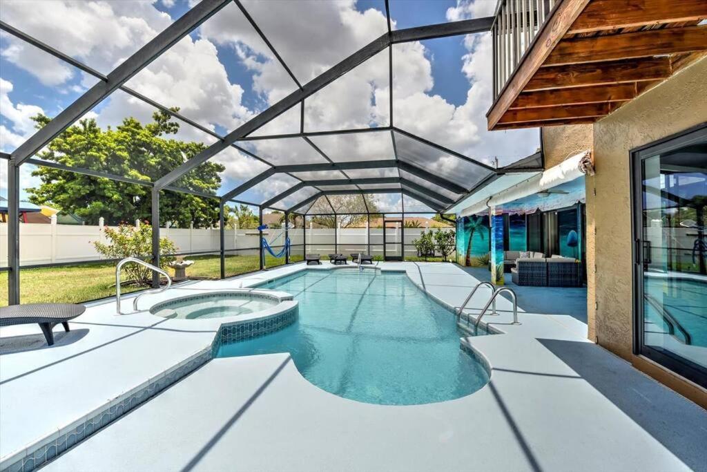 an indoor swimming pool with a glass roof at Cape Coral Paradise 4 BD 12sleeps, W/heated pool in Cape Coral