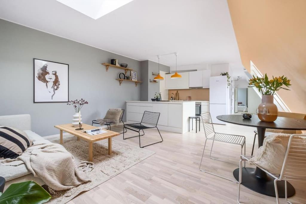 a living room with a couch and a table at Loft in the middle of Oslo City Center -2 bedrooms in Oslo