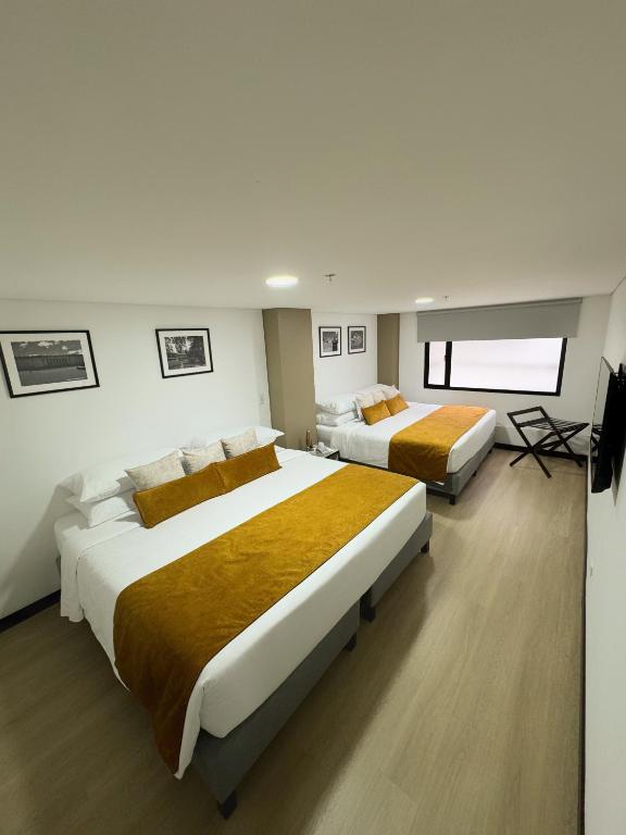 Postel nebo postele na pokoji v ubytování Hotel WLH Gold Bogota