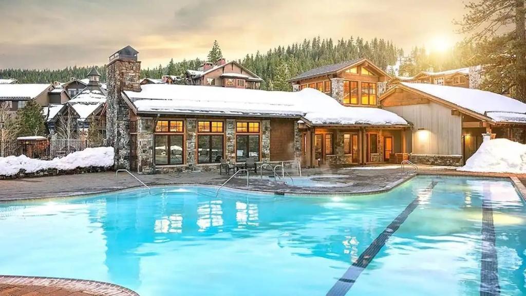 a house with a swimming pool in the snow at Spring Break! Luxurious Ski-In · Ski-Out Resort! in Truckee