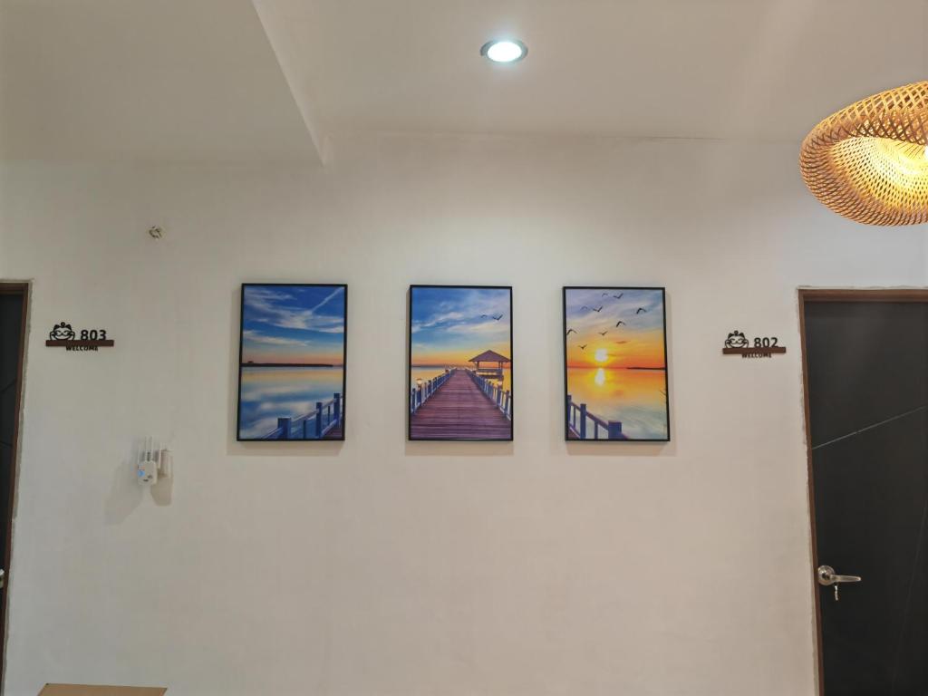 um grupo de quatro imagens numa parede em Padang Serai Cozy Roomstay Share Bathroom em Padang Serai