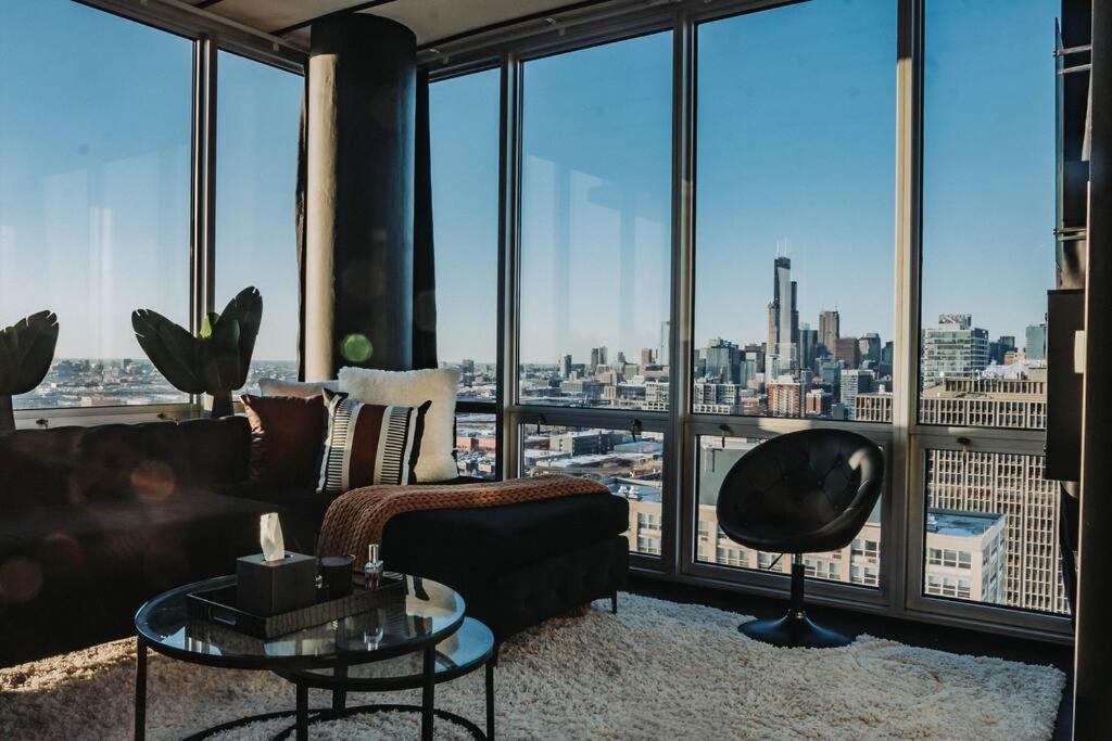 a living room with a couch and a large window at Stunning Panoramic Chicago Views & Free Parking in Chicago