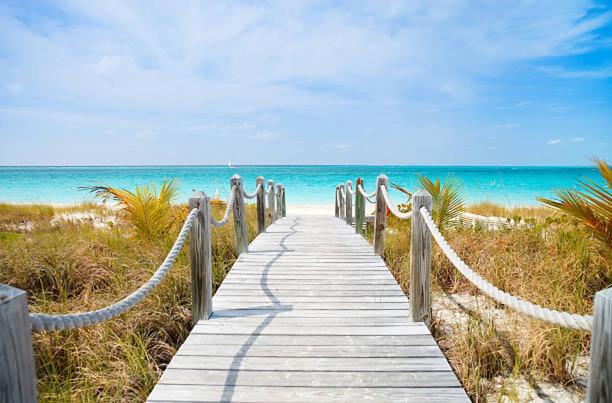 a wooden path to the beach with the ocean at COMPLIMENTARY CAR! Casa Del Mar! in Nassau