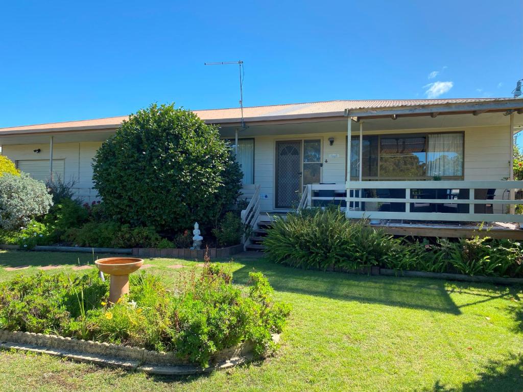 a house with a yard in front of it at Parnella Cottage - Pet friendly in St Helens