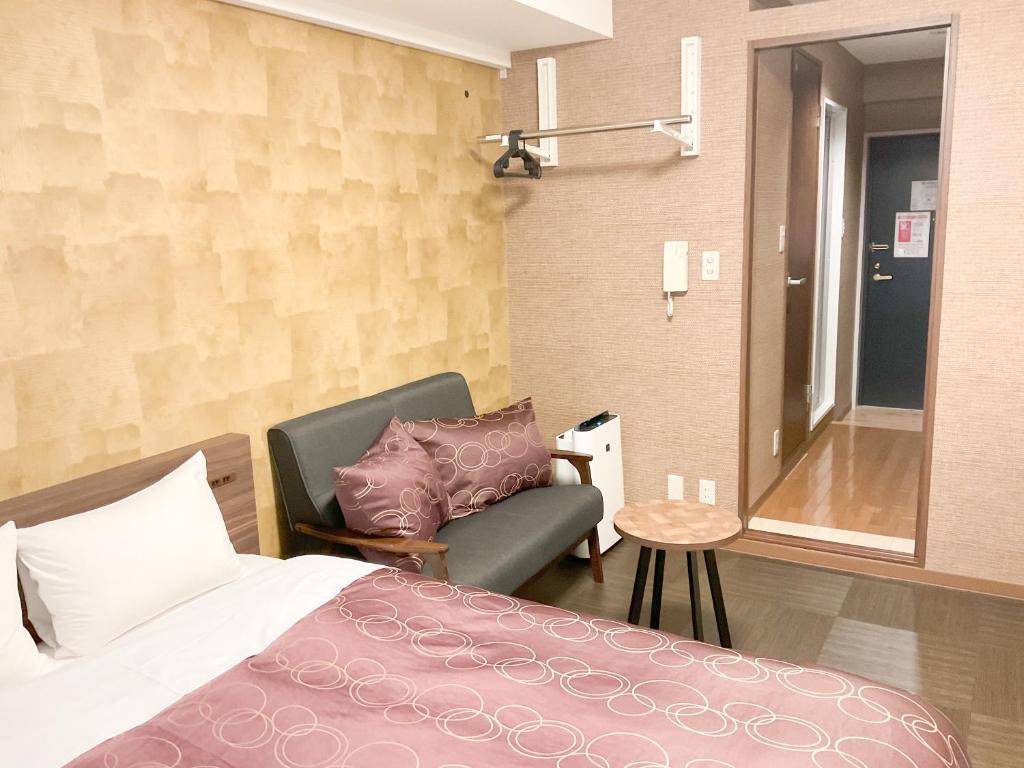 Vuode tai vuoteita majoituspaikassa Comfort stay Miyabi