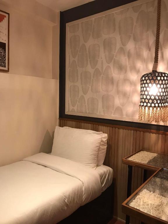 Postel nebo postele na pokoji v ubytování Jovinaj Travellers Inn
