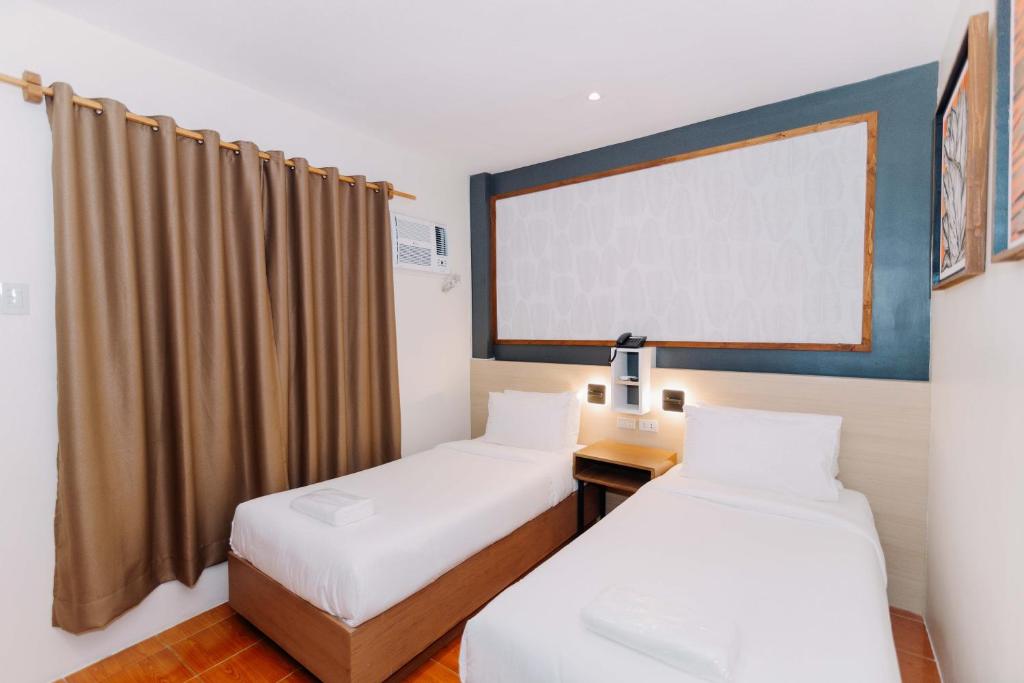 Postel nebo postele na pokoji v ubytování Jovinaj Travellers Inn