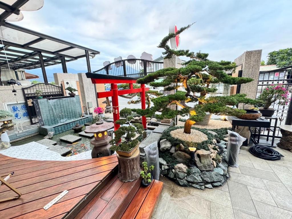 a christmas tree on a patio with a wooden bench at Love's World B&B in Ji'an