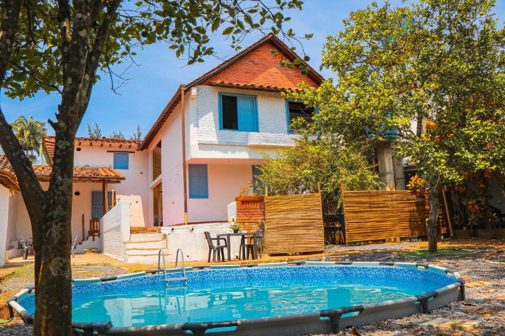 a house with a swimming pool in front of a house at Aura Hotel Parque Barichara in Barichara