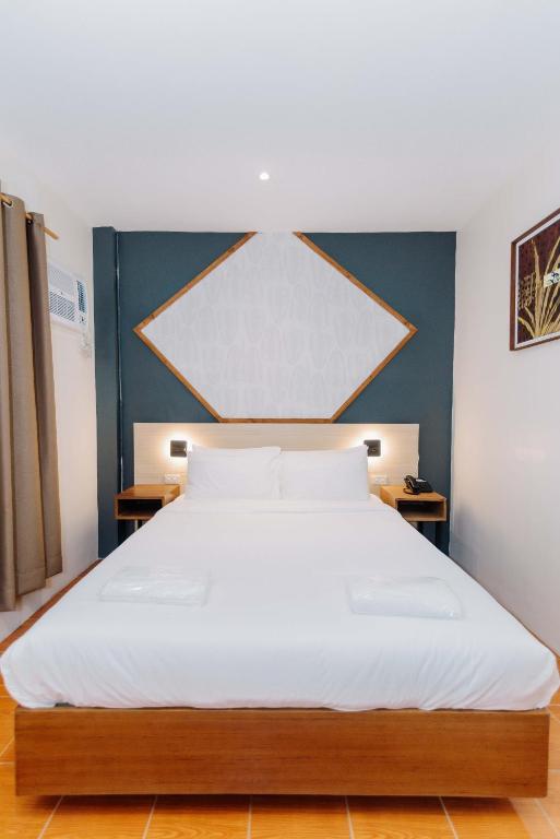 Postel nebo postele na pokoji v ubytování Jovinaj Travellers Inn
